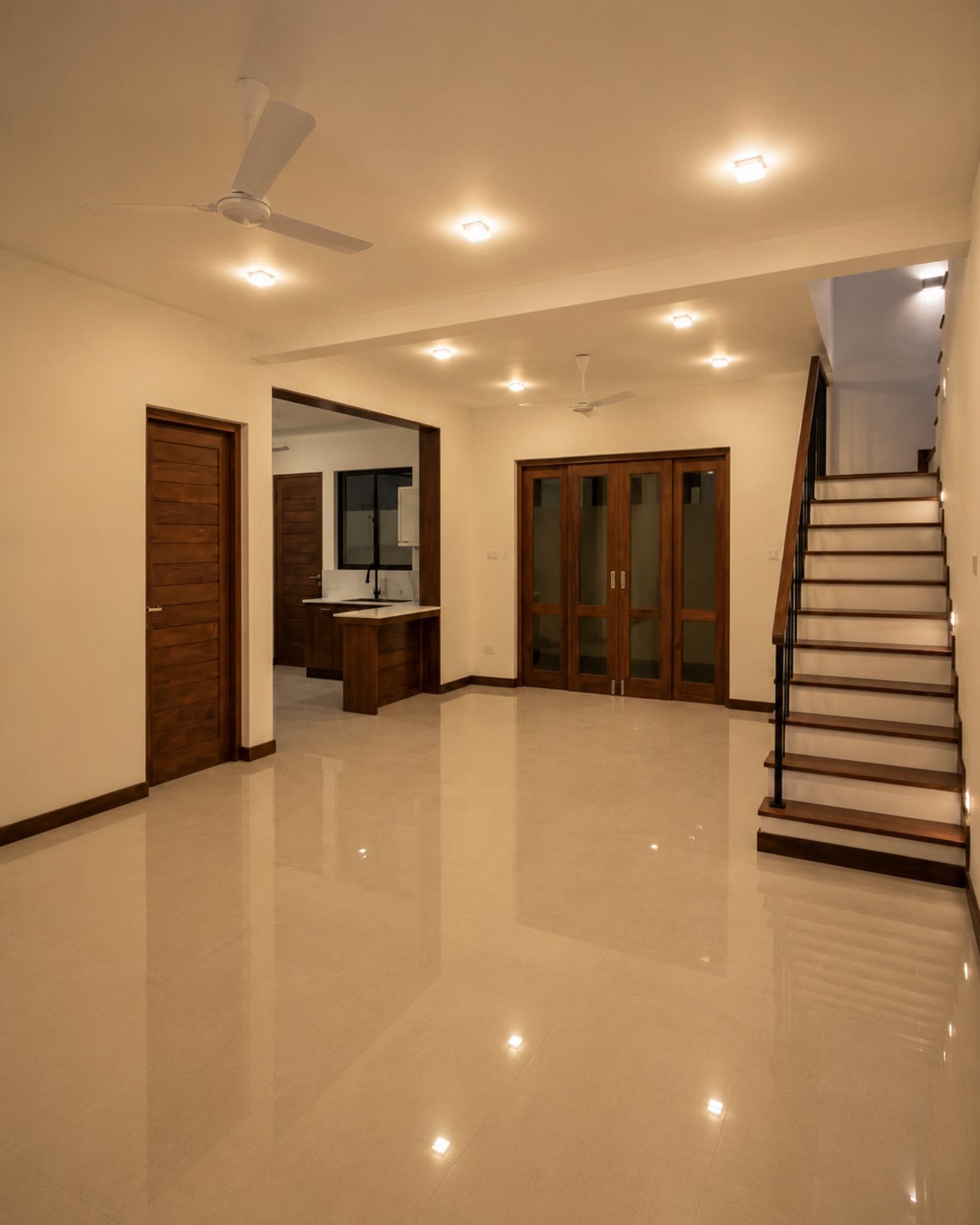 No. 11/11A, Saman Mawatha, Sirimal Uyana — living room with stair, kitchen and glazed doors beyond